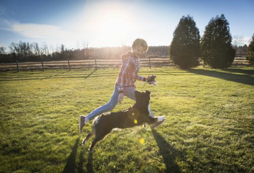 Boy running with dog